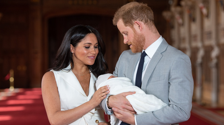 Meghan Markle and Prince Harry smiling at baby archie