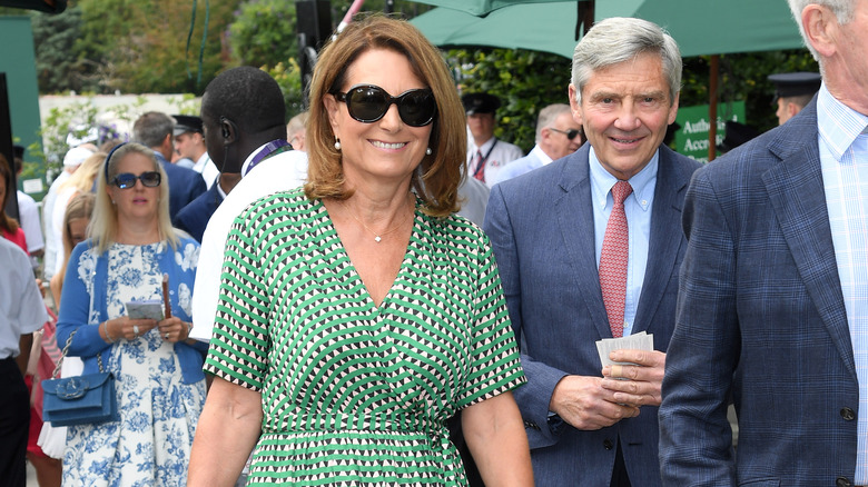 Carole and Michael Middleton walking through crowd smiling