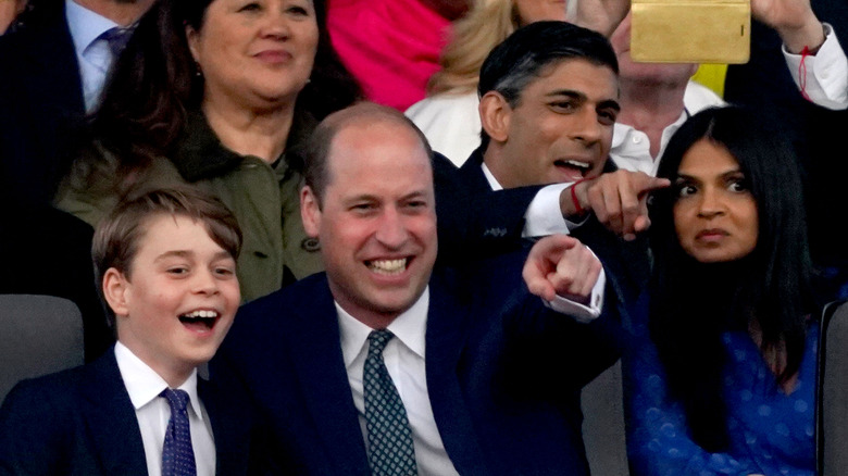 Prince William pointing and laughing with Prince George & Rishi Sunak