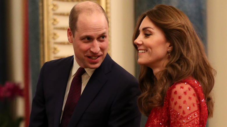 Prince William talking to Princess Catherine