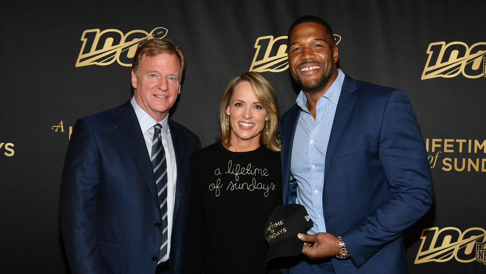 Jane Skinner posing with Roger Goodell and Michael Strahan