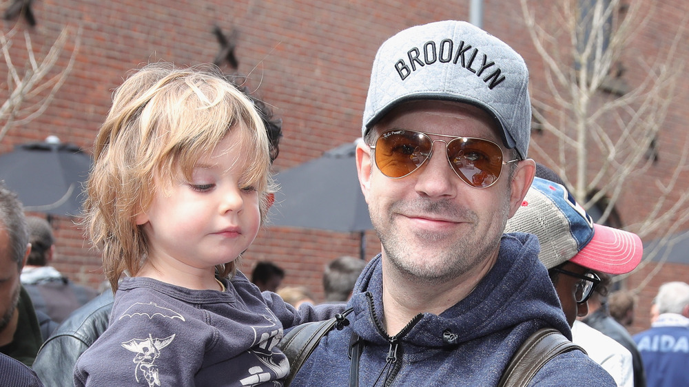 Jason Sudeikis holding his son, Otis 