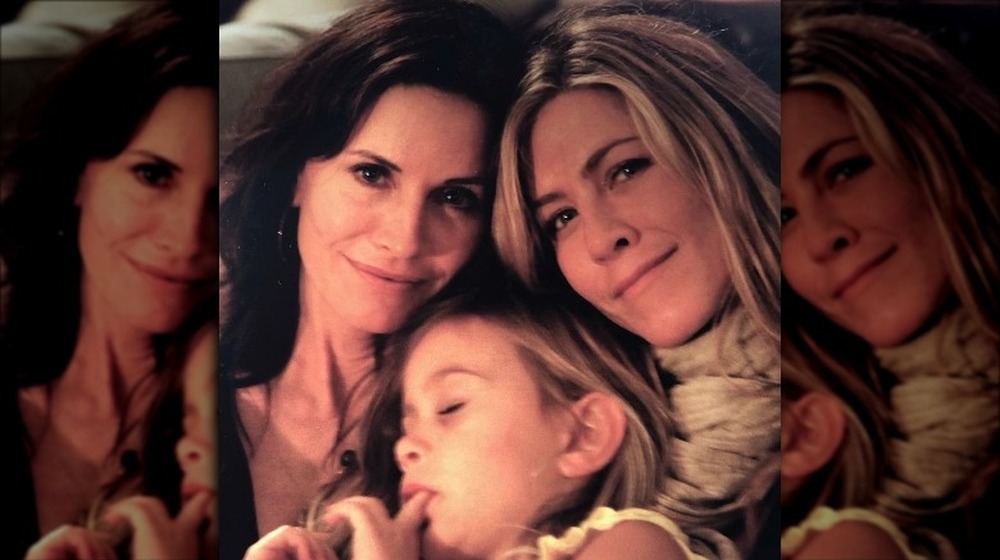 Jennifer Aniston, Courteney Cox, and Coco cuddle together