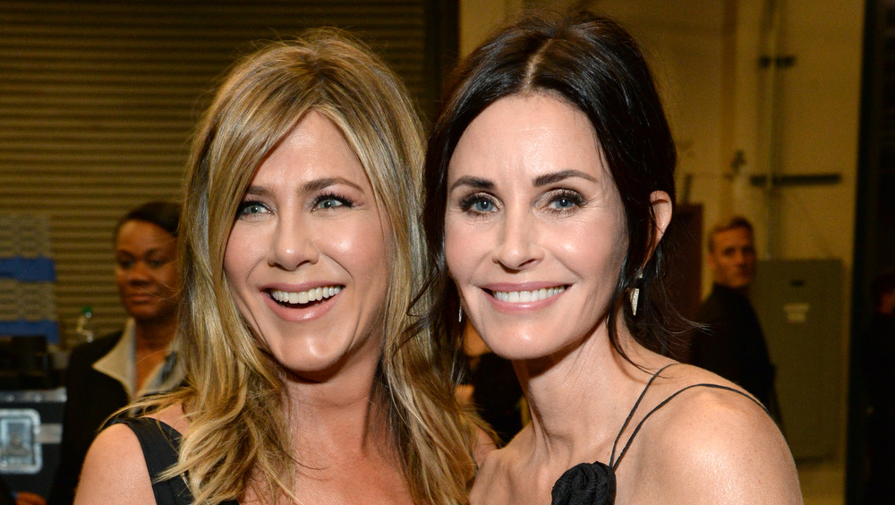 Jennifer Aniston and Courteney Cox smiling