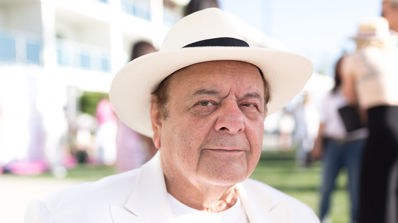 Paul Sorvino smiling all in white at an event