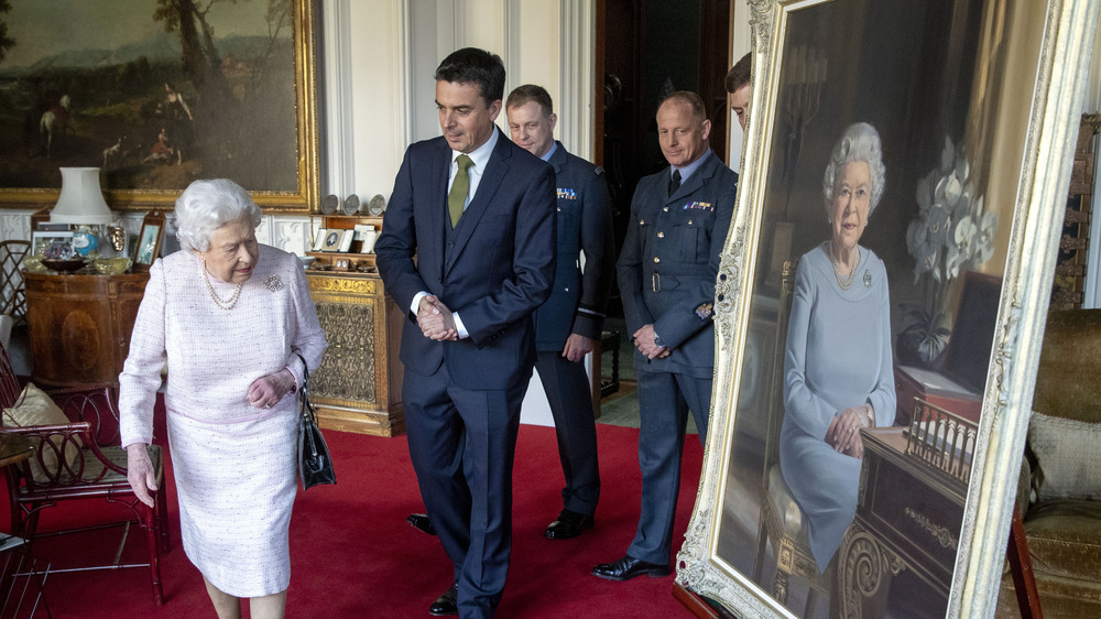 Queen Elizabeth looking at her portrait