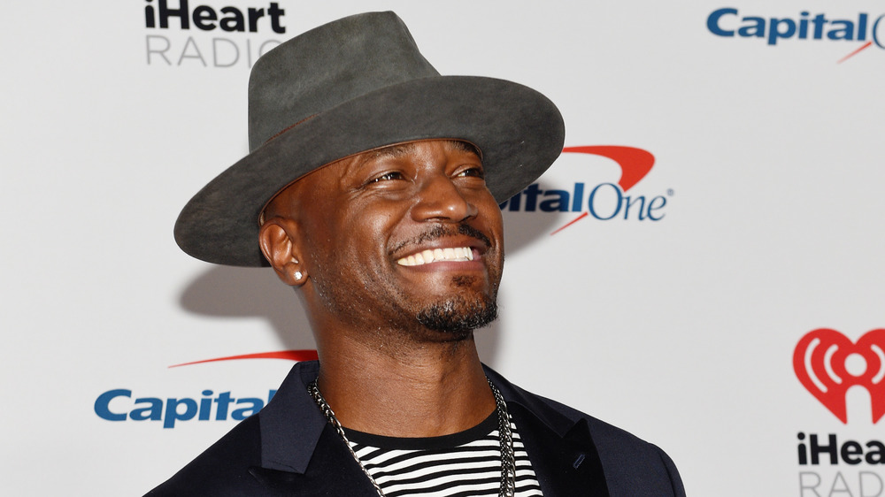 Taye Diggs looking up, smiling