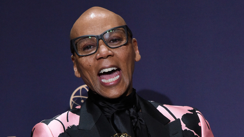 RuPaul wearing glasses, smiling 