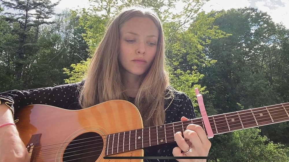 Amanda Seyfried playing the guitar