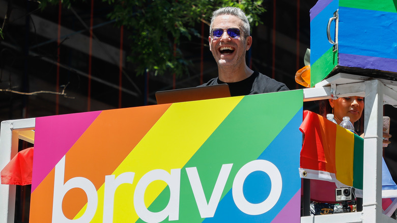 Andy Cohen with rainbow Bravo sign