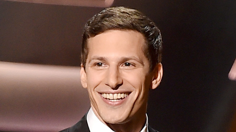 Andy Samberg smiles onstage