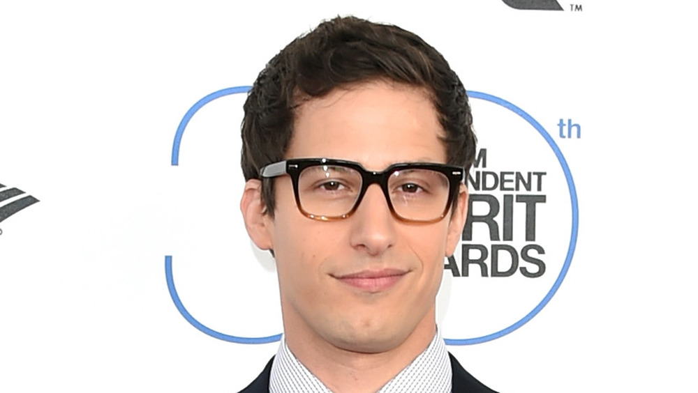 Andy Samberg smiles at an event