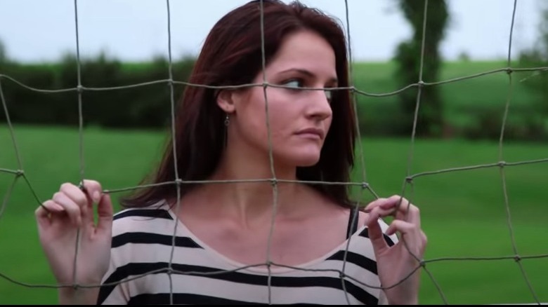 Kate Stoltz behind a fence