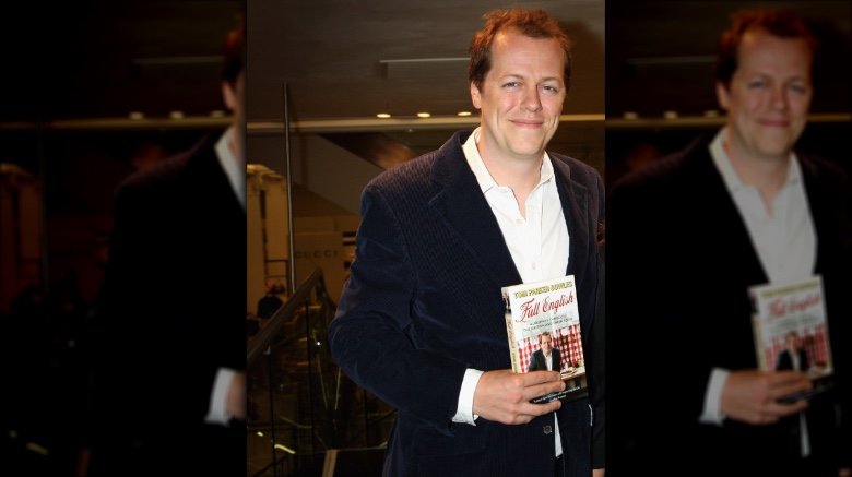 Tom Parker Bowles holding one of his cookbooks in 2009