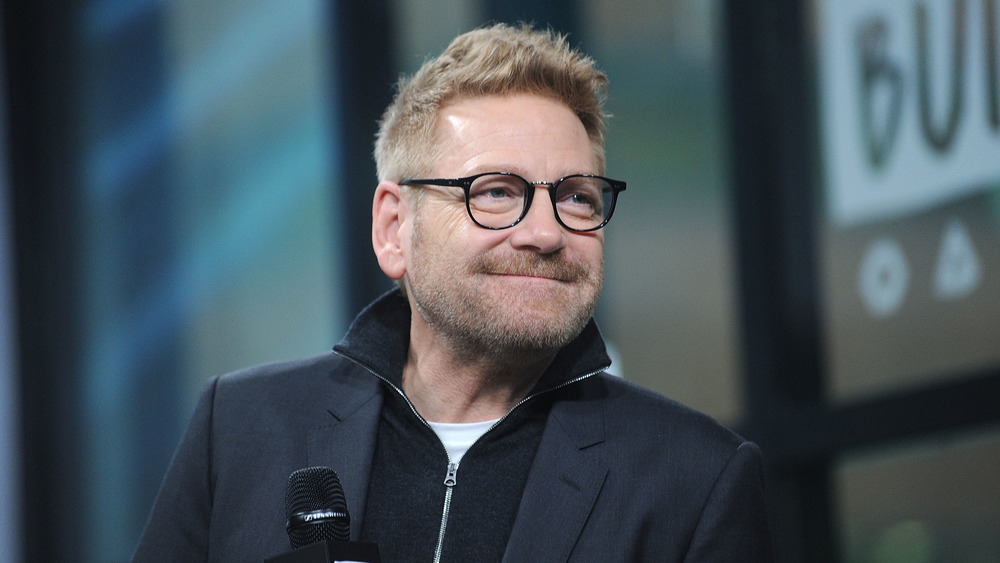 Kenneth Branagh smiling with glasses