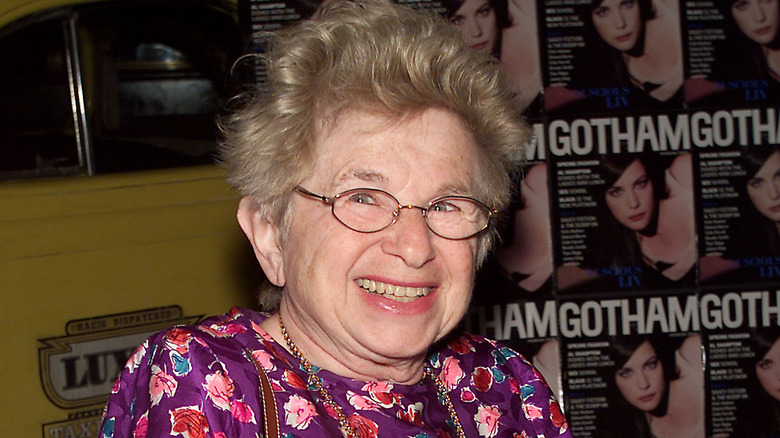 Dr. Ruth wears a purple dress.