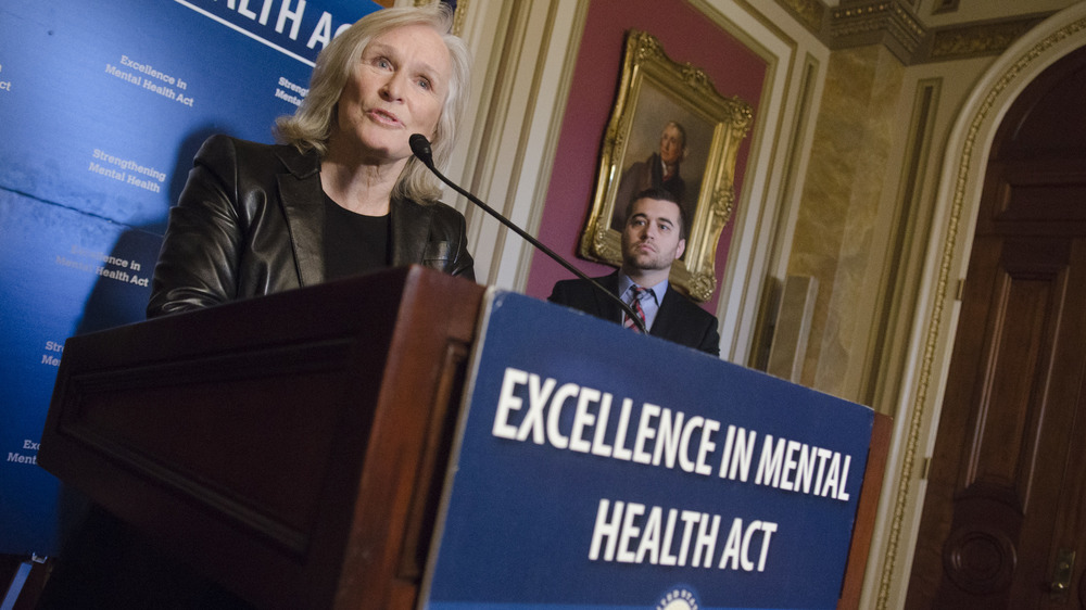 Glenn Close speaking at podium