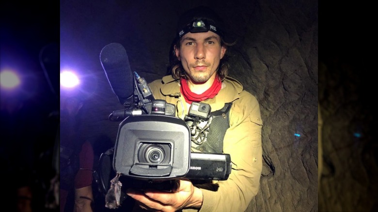 Parker Schnabel holding camera in cave