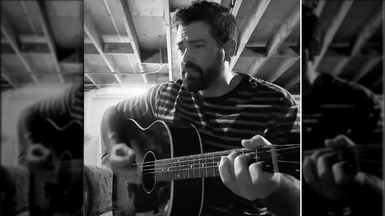 Jesse Metcalfe playing guitar