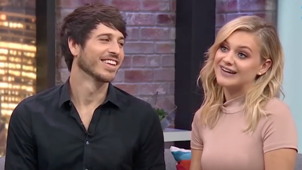 Kelsea Ballerini and Morgan Evans sitting next to each other