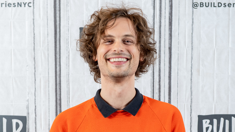 Matthew Gray Gubler in an orange sweater