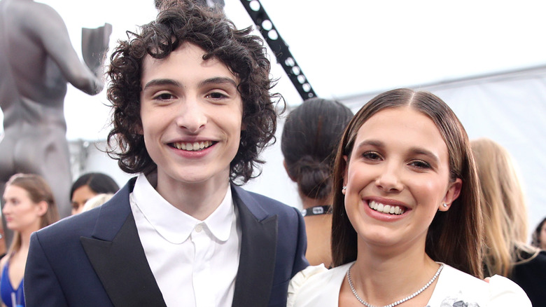 Millie Bobby Brown posing with Finn Wolfhard