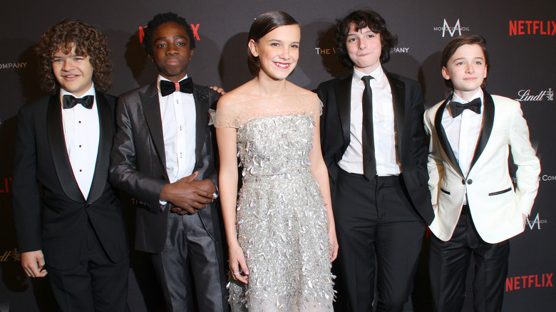 Millie Bobby Brown posing with the Stranger Things cast