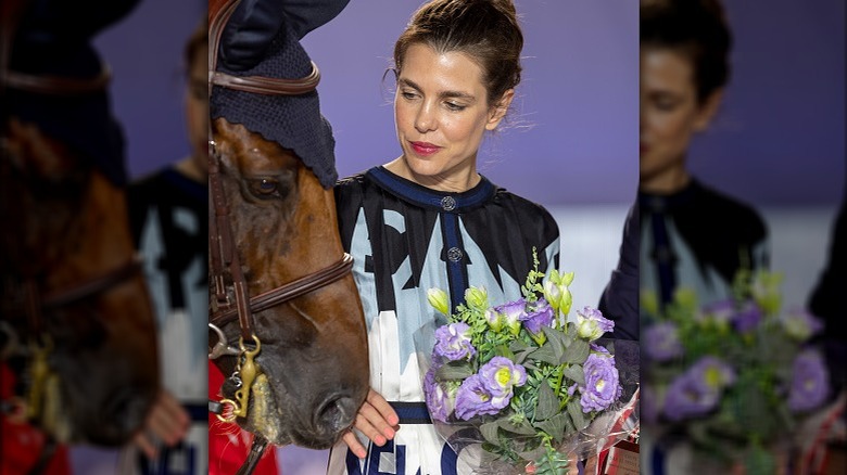 Charlotte Casiraghi looking at horse