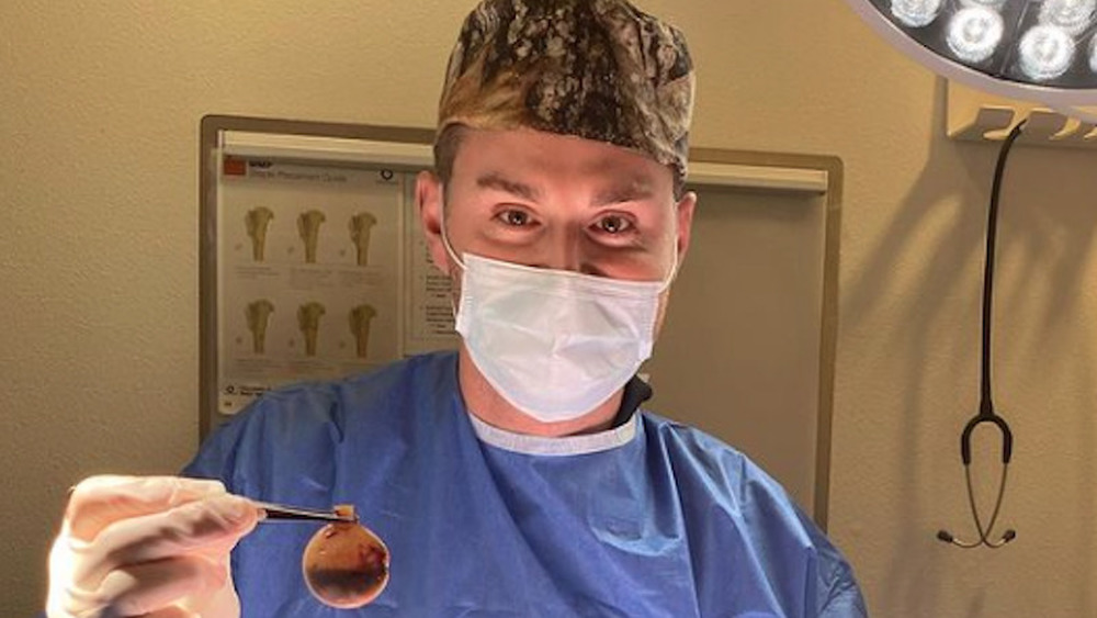 Dr. Grant Dunbar wears a mask amid surgery