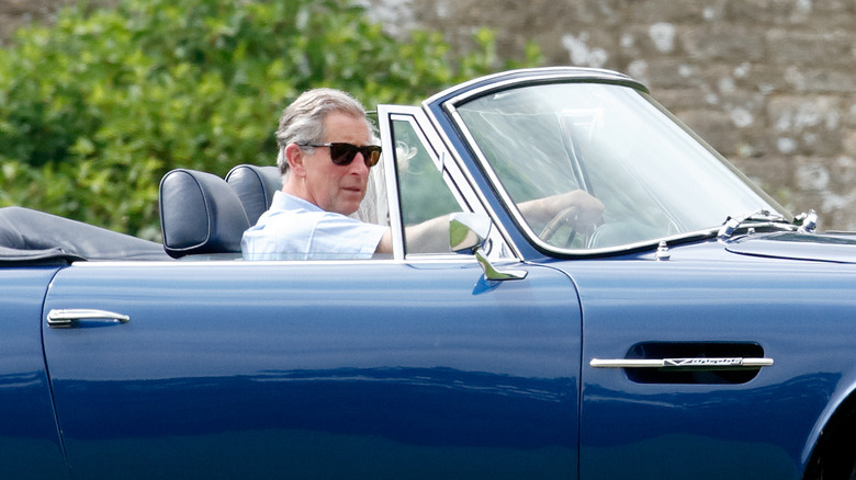 Prince Charles in a blue car