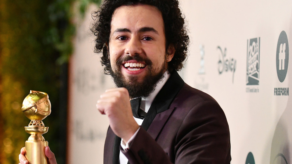 Ramy Youssef holding Golden Globe