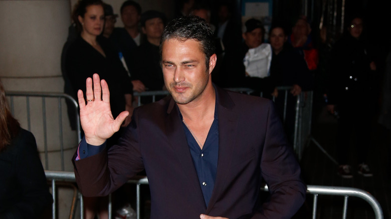 Taylor Kinney waving