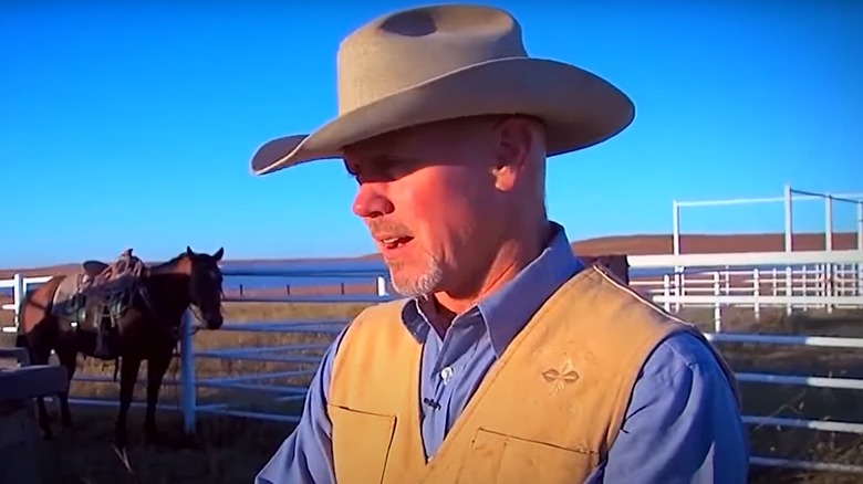 the Pioneer Woman's husband, Ladd Drummond, on the ranch with a horse