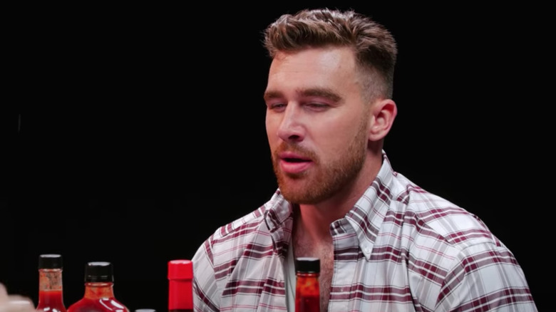 Travis Kelce looking unhappy on Hot Ones