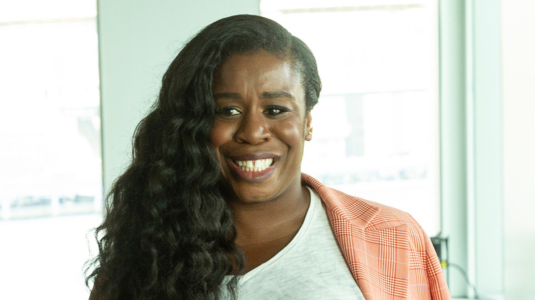 Uzo Aduba standing