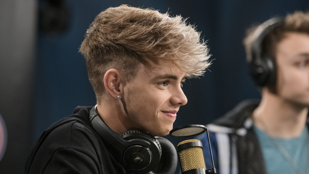 Corbyn Besson sitting in front of a microphone