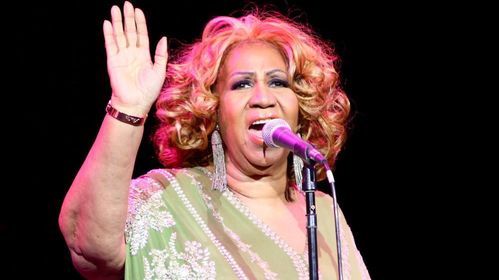 Aretha Franklin sings with curly blonde hair