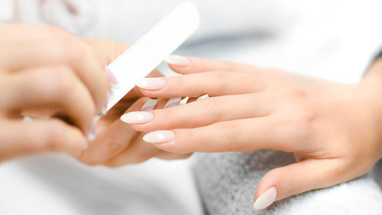 Woman filing nails