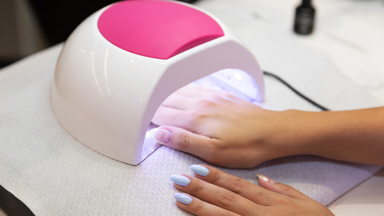 Woman putting hand under UV light