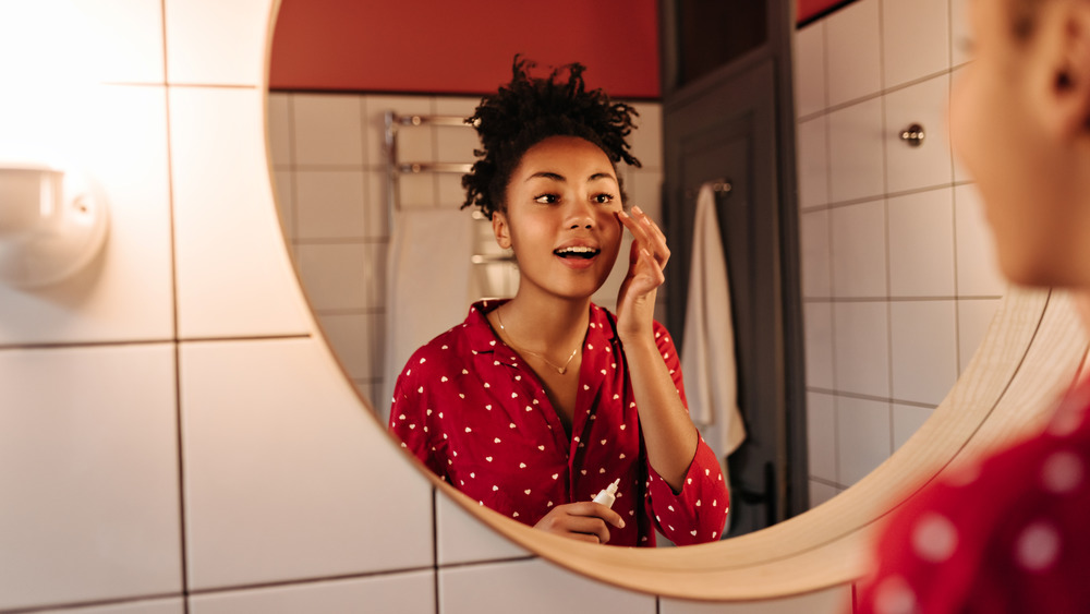 Woman putting on eye cream