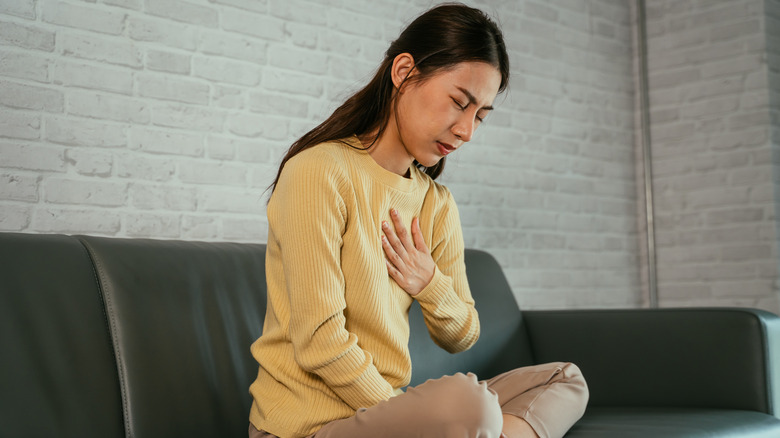 Woman experiencing pain in her one breast