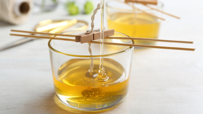 pouring wax into homemade candle