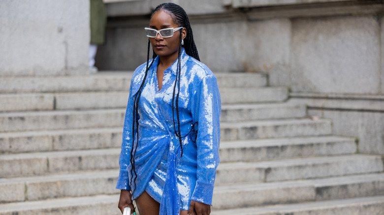 Black woman in blue sparkly mini dress