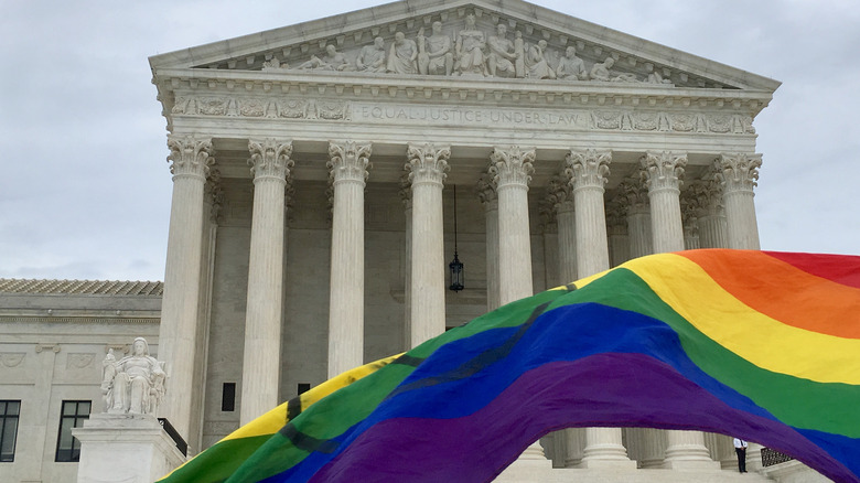 pride flag waving outside US government building