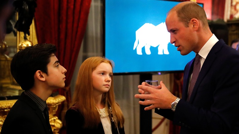Aidan Gallagher speaks with Prince William as part of his UN work