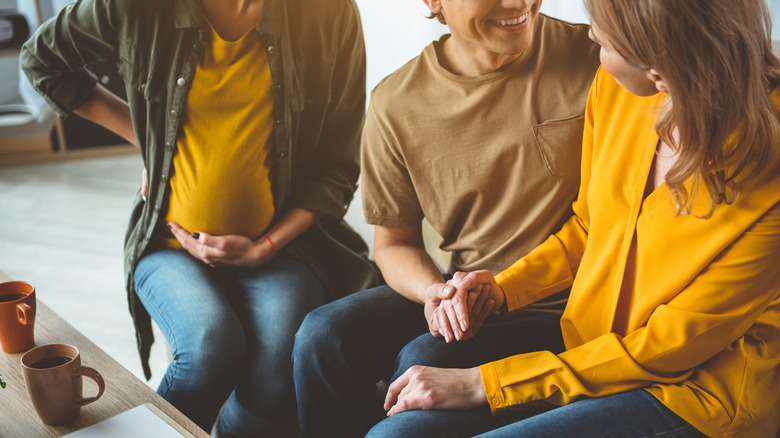 couple sitting with surrogate mother