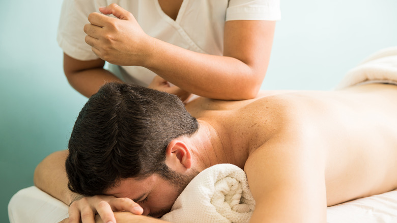 person receiving lomi lomi back massage