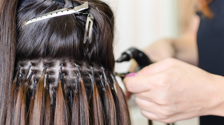 woman getting hair extensions