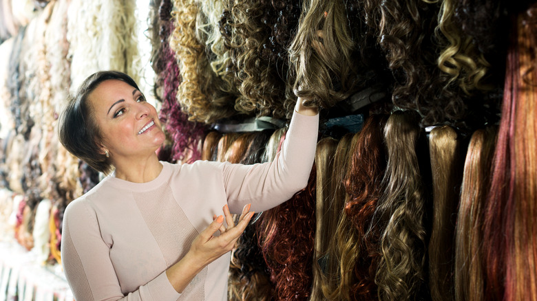 woman browsing through hair extensions