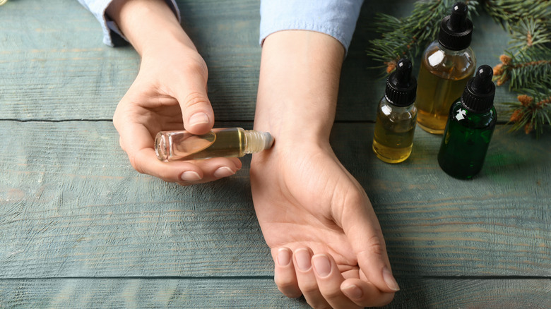 Woman using eucalyptus oil for skincare